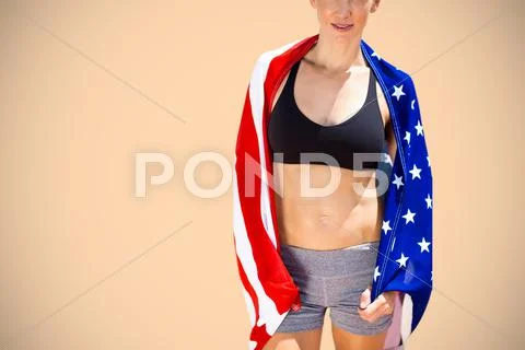 Composite image of sporty woman holding an american flag Stock Photos