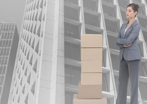 Composite image of stack of carboard boxes and caucasian businesswoman against 写真素材