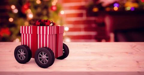 Composite image of striped white and red gift box with wheels Illustrazione stock