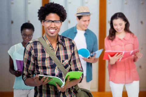 Composite image of stylish students smiling at camera together Stock Photos