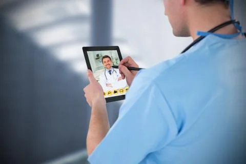 Composite image of surgeon using digital tablet Stock Photos