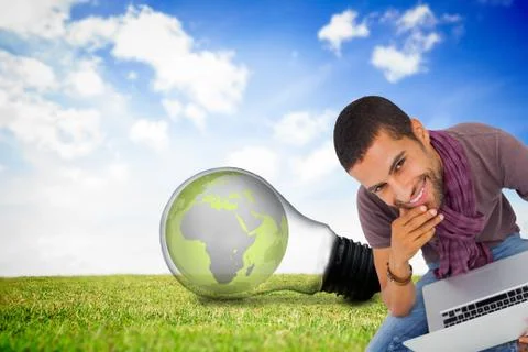 Composite image of thoughtful man sitting on floor using laptop and smiling at Stock Illustration