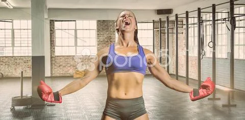 Composite image of winning fighter with arms outstretched Stock Photos