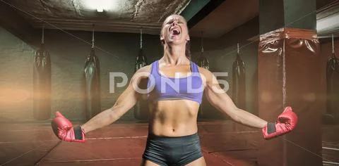 Composite image of winning fighter with arms outstretched Stock Photos