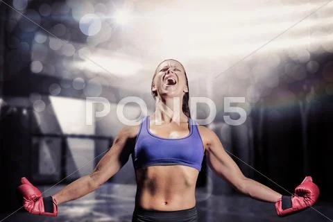 Composite image of winning fighter with arms outstretched Stock Photos