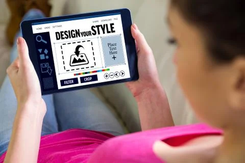 Composite image of woman using tablet at home Stock Photos