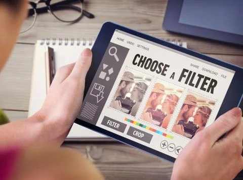 Composite image of woman using tablet pc Fotos de archivo