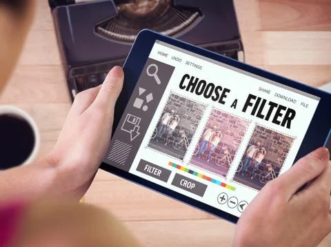 Composite image of woman using tablet pc Fotos de archivo