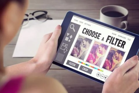 Composite image of woman using tablet pc Fotos de archivo