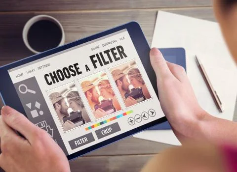 Composite image of woman using tablet pc Fotos de archivo