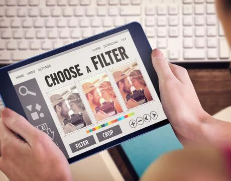 Composite image of woman using tablet pc Fotos de archivo