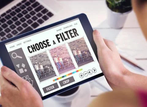 Composite image of woman using tablet pc Fotos de archivo