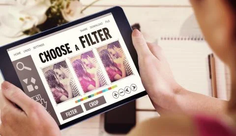 Composite image of woman using tablet pc Fotos de archivo