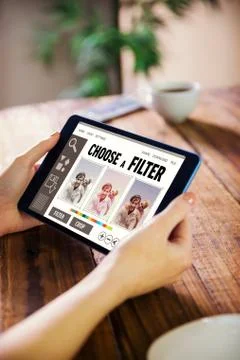 Composite image of woman using tablet pc Fotos de archivo