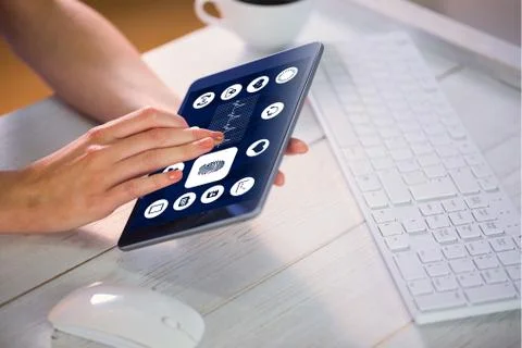 Composite image of woman using tablet at work Stock Photos