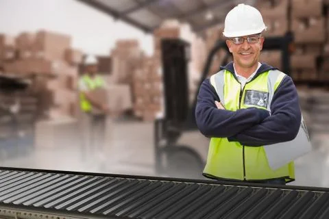 Composite image of worker wearing hard hat in warehouse Foto stock