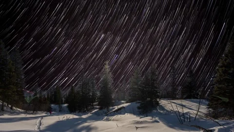 Composite time lapse of star trails moving behind a winter northern landscape Stock Footage 315133827