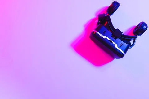 Composite of vr headset with copy space on neon background Stock Photos