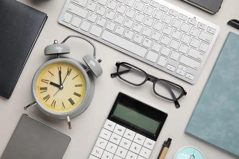 Composition with alarm clock, computer keyboard and eyeglasses on white backg Stock Photos