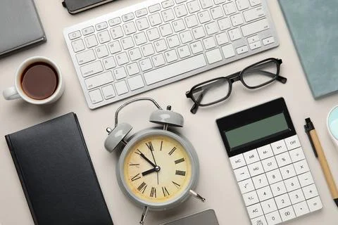 Composition with alarm clock, computer keyboard and cup of coffee on white ba Stock Photos