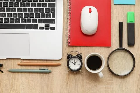 Composition with alarm clock, cup of coffee, modern laptop and stationery on  Stock Photos