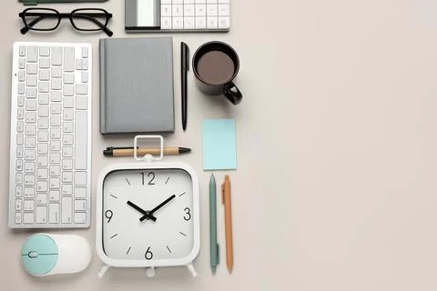 Composition with alarm clock, cup of coffee, computer keyboard and mouse on w Stock Photos