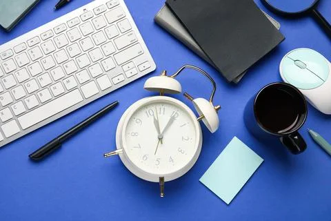 Composition with alarm clock, cup of coffee, computer keyboard and mouse on b Stock Photos