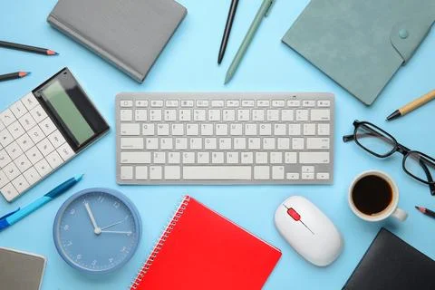 Composition with alarm clock, cup of coffee, computer keyboard and mouse on b Stock Photos