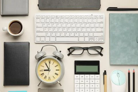 Composition with alarm clock, cup of coffee, computer keyboard and mouse on w Stock Photos