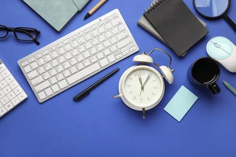 Composition with alarm clock, cup of coffee, computer keyboard and mouse on b Stock Photos