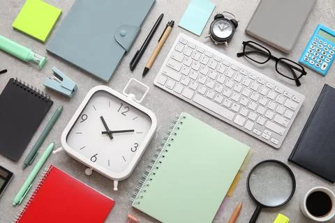 Composition with alarm clocks, computer keyboard and stationery on grey grung Stock Photos