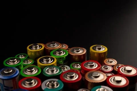 Composition with alkaline batteries on black background. Chemical waste. Top  Foto stock