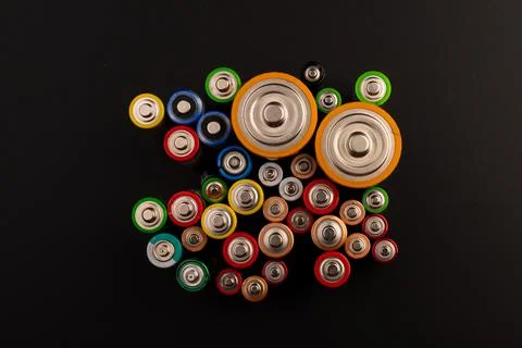 Composition with alkaline batteries on black background. Chemical waste. Top  Foto stock