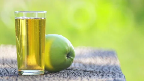 Composition, apple and apple juice outdoors. Stock Footage 114616923