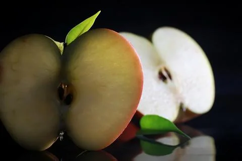 Composition with apple slices on a black background. A slice of apple with .. Foto stock