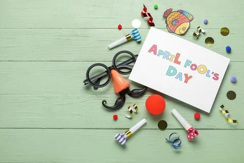 Composition with APRIL FOOLS DAY greeting card, funny glasses and confetti on Stock Photos