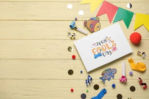 Composition with APRIL FOOLS DAY greeting card, confetti and bunting on yello Stock Photos