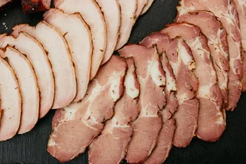 Composition of aromatic, smoked cold cuts. 库存照片
