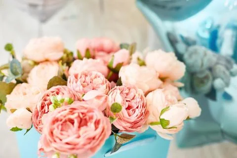 Composition of artificial pink peonies in a blue box. postcard Stock Photos