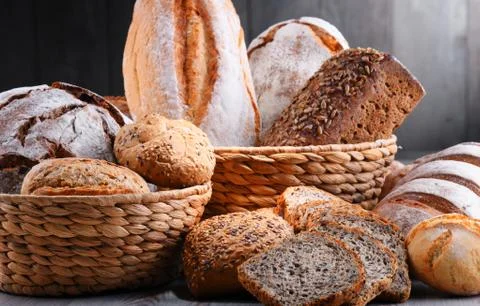 Composition with assorted bakery products in wicker basket Stock Photos