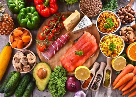 Composition with assorted food products on kitchen table. Stock Photos
