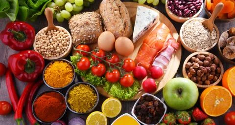 Composition with assorted organic food products on wooden kitchen table. Foto stock