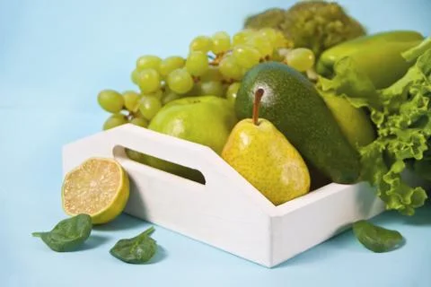 Composition with assorted raw organic green vegetables and friuts on the whit Fotos Stock