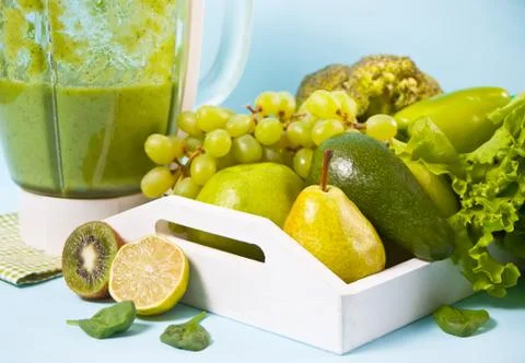 Composition with assorted raw organic green vegetables and friuts on the whit Stock Photos