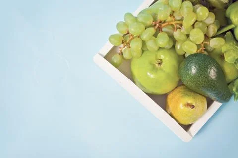 Composition with assorted raw organic green vegetables and friuts on the whit Stock Photos