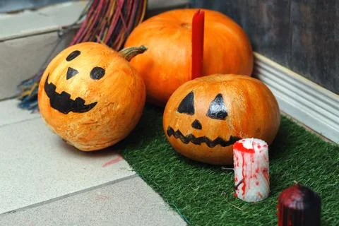 Composition, background for Halloween. Painted pumpkins, candles and a broom  Fotos de archivo