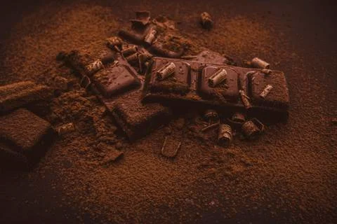 Composition of bars and pieces of different milk and dark chocolate, grated c Stock Photos