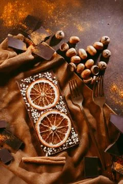 Composition of bars and pieces of different dark chocolate with orange slices Stock Photos