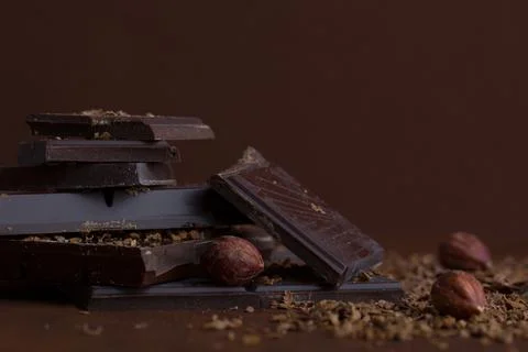 Composition of bars and pieces of different milk and dark chocolate, grated.. Stock Photos