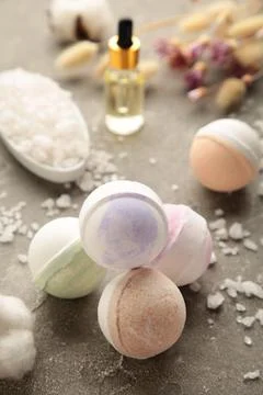 Composition with bath bombs, sea salt, dry flowers on grey background Stock Photos